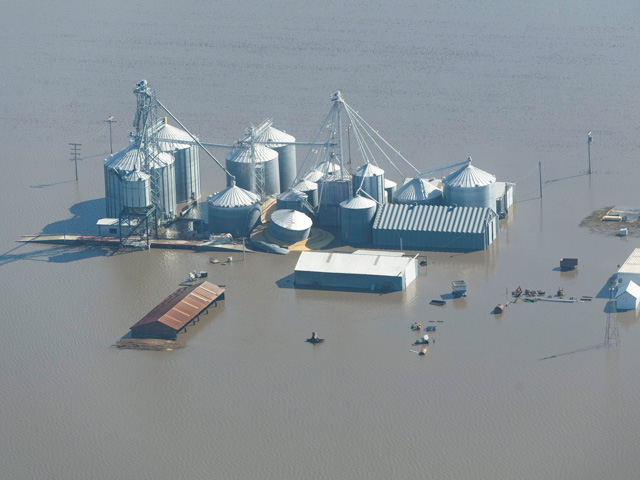 Floodwater from the overflowing Missouri River completely surrounds these grain bins in Fremont County, Iowa. (Photo by Joseph L. Murphy)